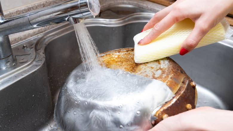 metal pan being washed