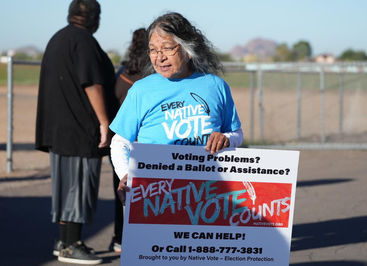 Attorney Diane Enos checks with voters to see if they had any problems casting their ballot at the Salt River Tribal Recreation Center in Scottsdale, Arizona, Tuesday morning.