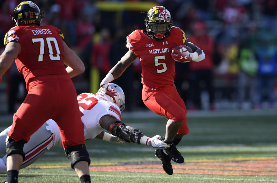 Maryland running back Anthony McFarland (5) runs the ball against Ohio State defensive tackle Haskell Garrett (92) during the first half of an NCAA football game, Saturday, Nov. 17, 2018, in College Park, Md. Also seen is Maryland offensive lineman Sean Christie (70). (AP Photo/Nick Wass)