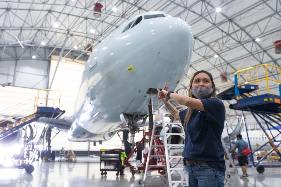 Mariah Passman of AAR gives a tour of the South hangar in which planes receive maintenance, repairs and overhauls at AAR Wednesday, May 26, 2021, in Rockford.