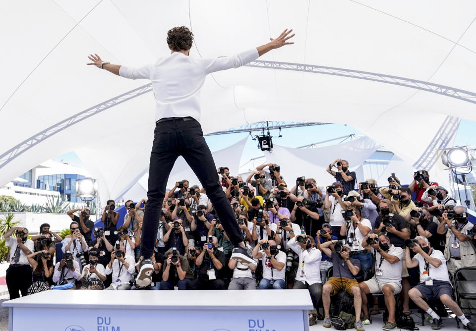 FILE - In this July 17, 2021 file photo Pierre Niney jumps from the plinth at the photo call for the film 'OSS 117: From Africa with Love' at the 74th international film festival, Cannes, southern France. (AP Photo/Brynn Anderson, File)