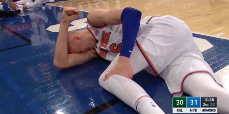 Kristaps Porzingis reached for his left knee immediately after his dunk against the Bucks. (Screencap via NBA)