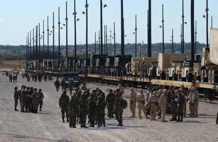 United States Army soldiers gather near vehicles on rail cars, as troops at the Fort Hood Army Base prepare for a massive January troop deployment to Iraq. (Photo by Robert Daemmrich Photography Inc/Corbis via Getty Images)