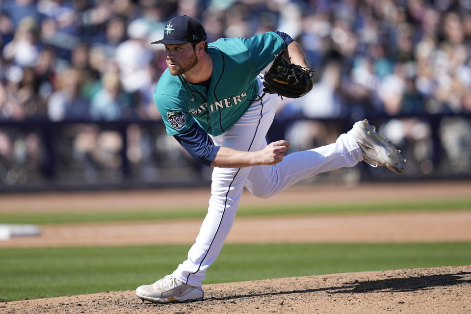 Seattle Mariners relief pitcher Chris Clarke delivers during the fifth inning of a spring training baseball game against the Texas Rangers, Sunday, March 12, 2023, in Peoria, Ariz. (AP Photo/Abbie Parr)