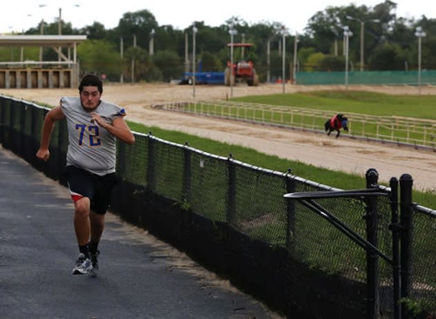 Lyman lineman Brock Merritt attempts to hold off a canine competitor — Orlando Sentinel