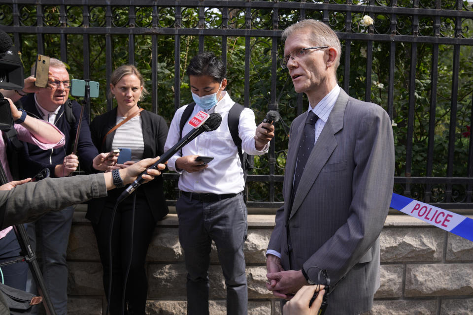 Australian ambassador to China Graham Fletcher, right, speaks to reporters near a barricade tape outside the No. 2 Intermediate People's Court after he was denied to attend the espionage charges case for Yang Hengjun, in Beijing, Thursday, May 27, 2021. Fletcher said it was “regrettable” that the embassy was denied access Thursday as a trial was due to start for Yang, a Chinese Australian man charged with espionage. (AP Photo/Andy Wong)