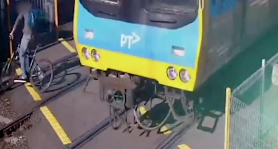 A cyclist’s close call while crossing in front of a speeding Melbourne train. Source: 7 News