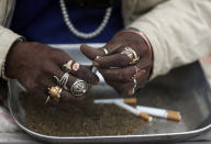 A Hindu holy man prepares marijuana to sell during Shivaratri festival at the premises of Pashupatinath temple in Kathmandu, Nepal, Friday, Feb. 21, 2020. Hindu holy men were joined by devotees and the public Friday at a revered temple in Kathmandu where they lit up marijuana cigarettes during an annual festival despite prohibition and warning by authorities. Hindu holy men were joined by devotees and the public Friday at a revered temple in Kathmandu where they lit up marijuana cigarettes during an annual festival despite prohibition and warning by authorities. “There is a ban on smoking marijuana but at the same time it is centuries-old tradition which we have to respect,”said police officer Suman Khadka adding there was no arrests made Friday. (AP Photo/Niranjan Shrestha)