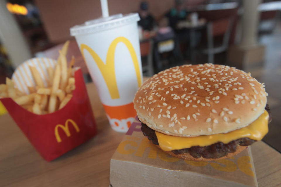 A McDonald's meal of a cheeseburger, fries, and a beverage