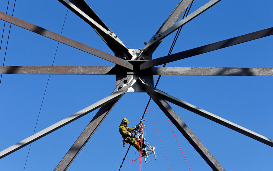 A technician works on high-voltage line