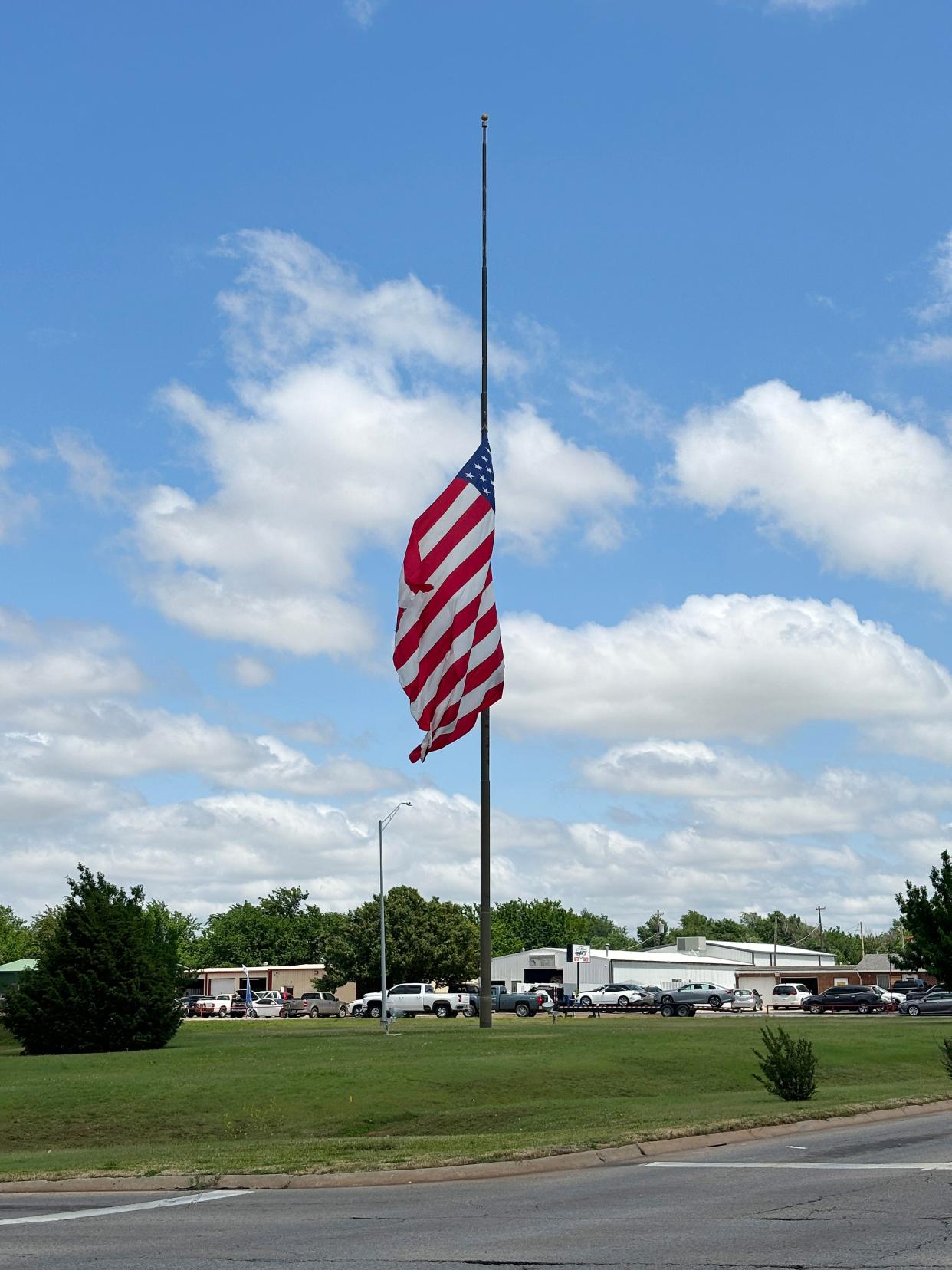 A flag in Moore flies at half-staff Friday in honor of longtime Moore Mayor, Glenn Lewis, whose funeral was on the 25th anniversary of the May 3, 1999, tornado that hit Moore.