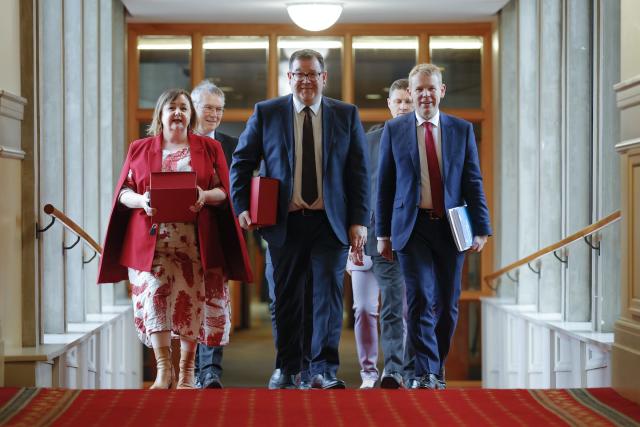 Senior cabinet minister Megan Woods, Minister of Finance Grant Robertson and Prime Minister Chris Hipkins prepare to deliver the May 18 budget. Getty Images