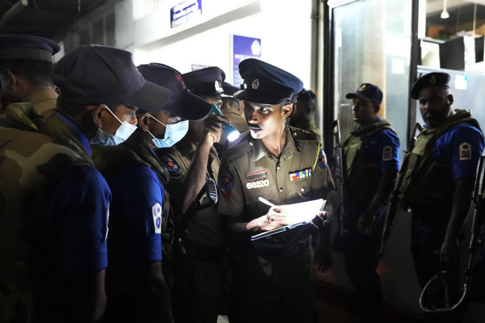 A Sri Lankan police officer records details of Navy soldiers as they prepare for a search operation against narcotics at a neighborhood in Colombo, Sri Lanka, Thursday, Jan. 18, 2024. (AP Photo/Eranga Jayawardena)