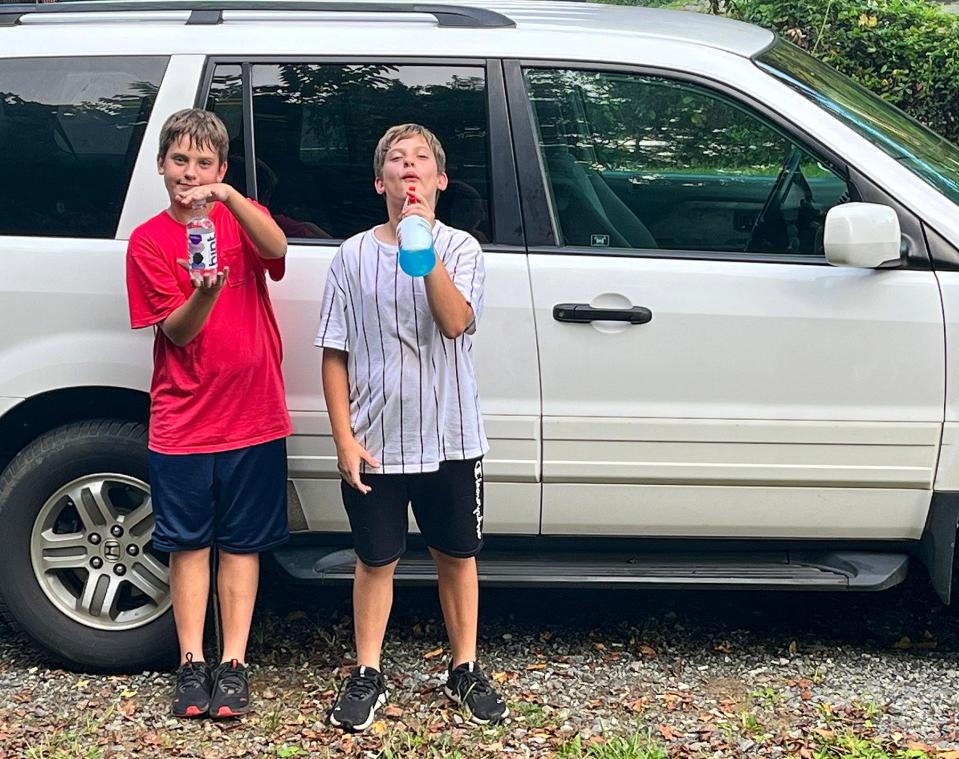 Austin and Jayden Schuit are pictured with the Honda Pilot purchased by their mother, Brittney Schuit, through Working Wheels.