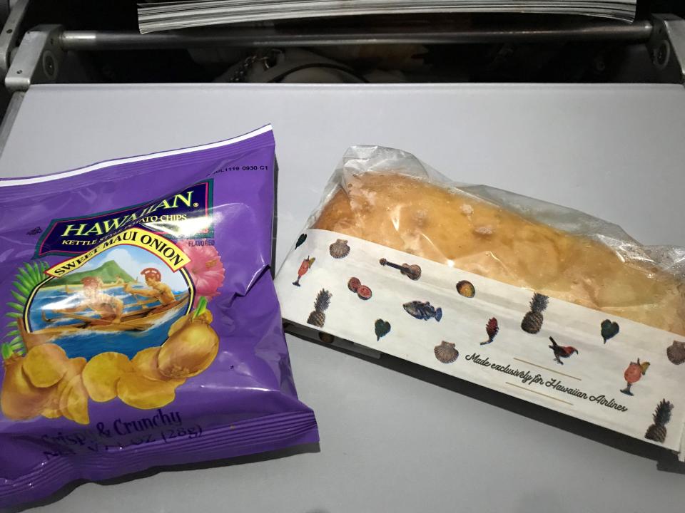 Hawaiian Airlines' light meal includes a sandwich and chips with an island flair.