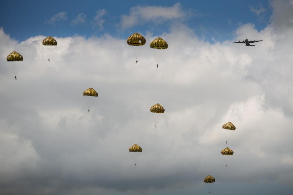 PHOTO: Paratroopers from the British, Belgian, Canadian and US military take part in a parachute drop in the fields of Sannerville as they reenact the D-Day landings of 80 years ago, June 5, 2024, in Sannerville, France.  (Christopher Furlong/Getty Images)