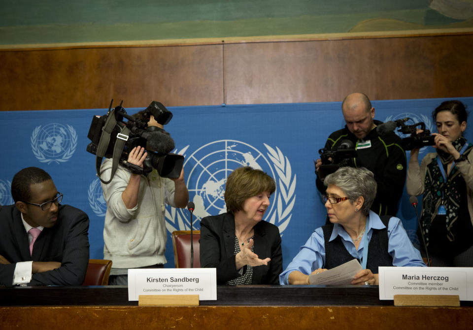 Kirsten Sandberg, center, chairperson of the U.N. human rights committee on the rights of the child, talks to committee members Maria Herczog, right, and Benyam Mezmur during a press conference at the United Nations headquarters in Geneva, Switzerland, Wednesday, Feb. 5, 2014. A U.N. human rights committee denounced the Vatican on Wednesday for adopting policies that allowed priests to rape and molest tens of thousands of children over decades, and urged it to open its files on the pedophiles and the churchmen who concealed their crimes. (AP Photo/Anja Niedringhaus)