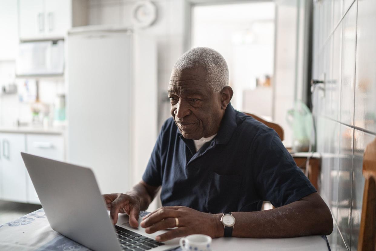 Senior man looking at laptop 