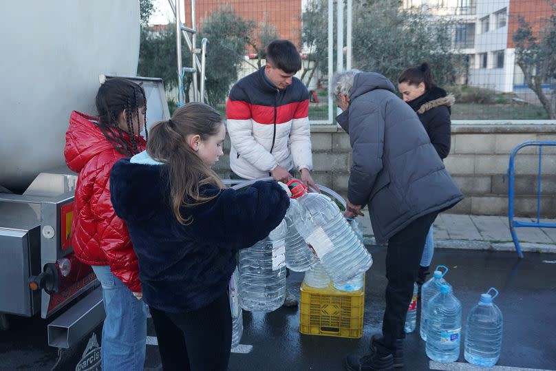 People in Pozoblanco fill up on clean drinking water from a tanker.