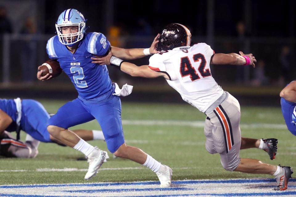 Olentangy Berlin quarterback Harrison Brewster stiff-arms Delaware Hayes' Sawyer Sand during the Bears' 42-24 win Oct. 28.