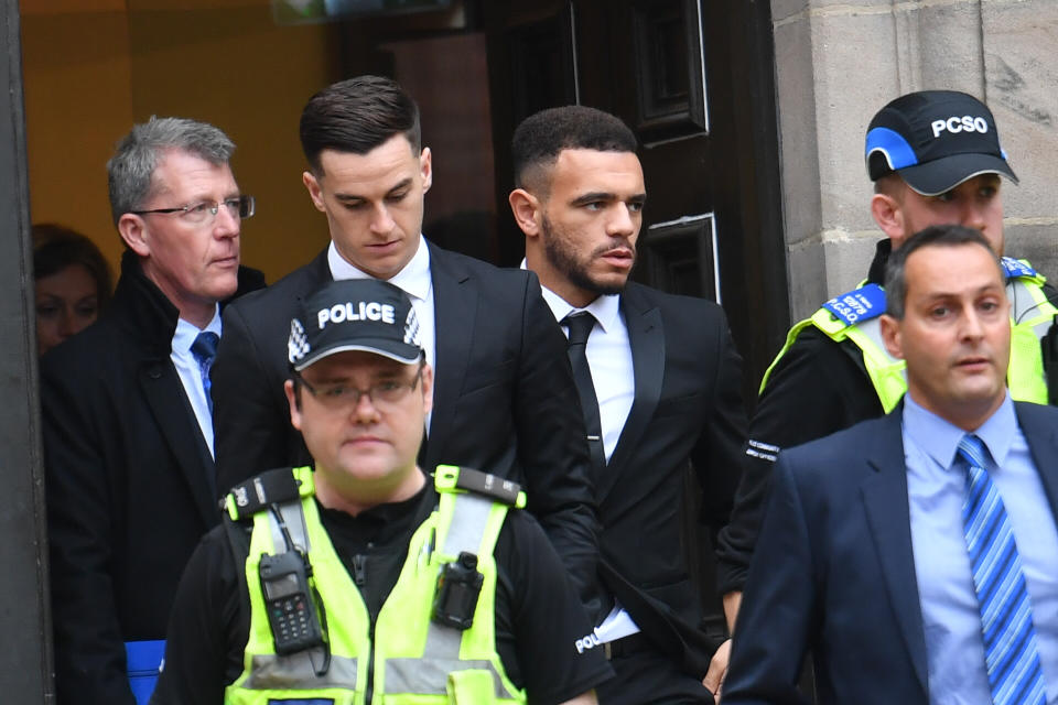 Police escort Derby County footballers Tom Lawrence (centre left) and Mason Bennett (centre right) from Derby Magistrates' Court, where they have avoided prison after they admitted drink-driving over a crash which left their club captain seriously injured.