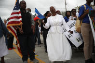 <p>Jocelyne Pierre (C) joins with others to mark the 8th anniversary of the massive earthquake in Haiti and to condemn President Donald Trump’s reported statement about immigrants from Haiti, Africa and El Salvador on Jan. 12, 2018 in Miami, Fla. (Photo: Joe Raedle/Getty Images) </p>