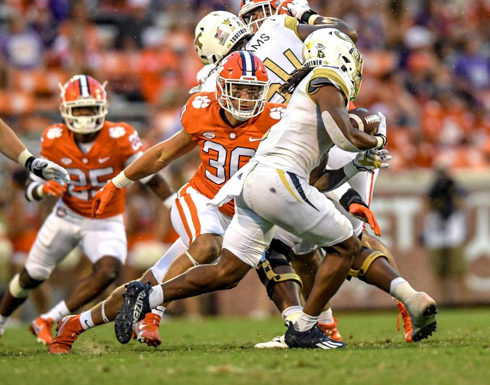 Clemson linebacker Keith Maguire (30) pursues Georgia Tech freshman Jahmyr Gibbs (1) during the third quarter in Clemson, S.C., September 18, 2021. 