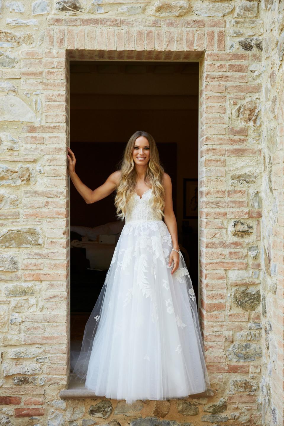 Caroline posing for bridal portraits before the ceremony. Her hair was done in soft waves by Dayna Goldstein using Kérastase products.