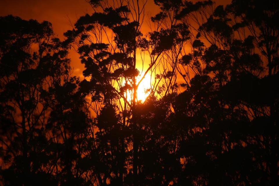 A red sunset as the fire front approaches Potato Point on NSW South Coast, 23 January