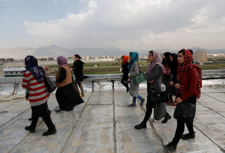 Female students of American University of Afghanistan walk on the roof of a building during a security training and new orientation sessions at a American University in Kabul. REUTERS/Mohammad Ismail