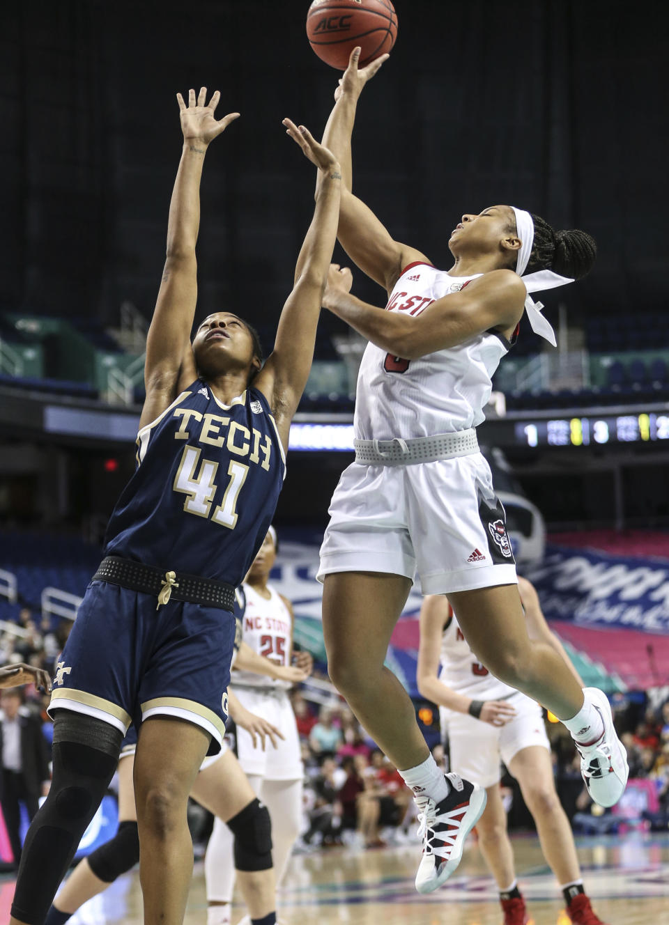 North Carolina State's Kai Crutchfield, left, shoots next to Georgia Tech's Kierra Fletcher during an NCAA college basketball game in the Atlantic Coast Conference women's tournament in Greensboro, N.C., Friday, March 6, 2020. (Khadejeh Nikouyeh/News & Record via AP)