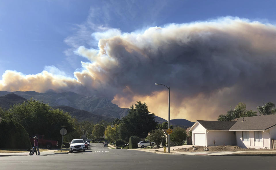 A large wildfire plume emerges over Lake Sherwood, California. Image: AP