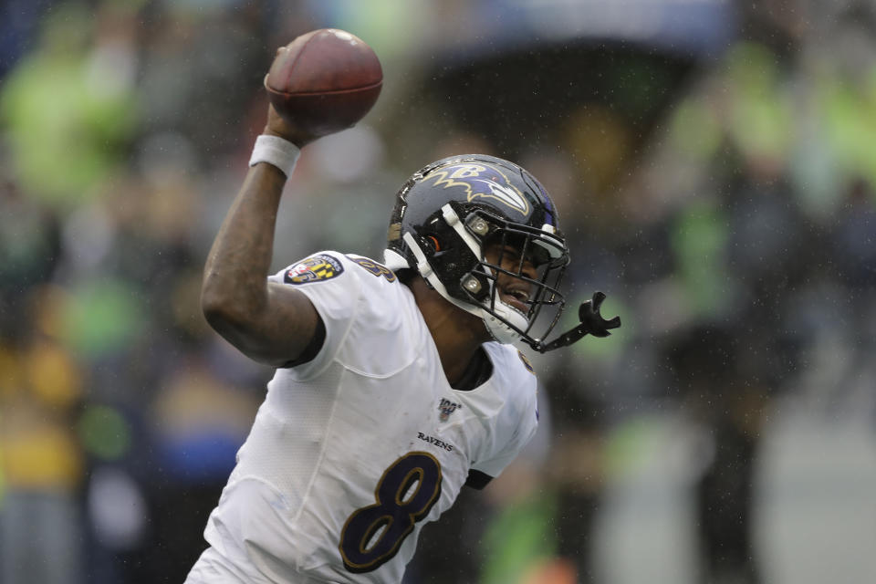Baltimore Ravens quarterback Lamar Jackson (8) spikes the ball after a touchdown during the second half of an NFL football game against the Seattle Seahawks, Sunday, Oct. 20, 2019, in Seattle. (AP Photo/John Froschauer)