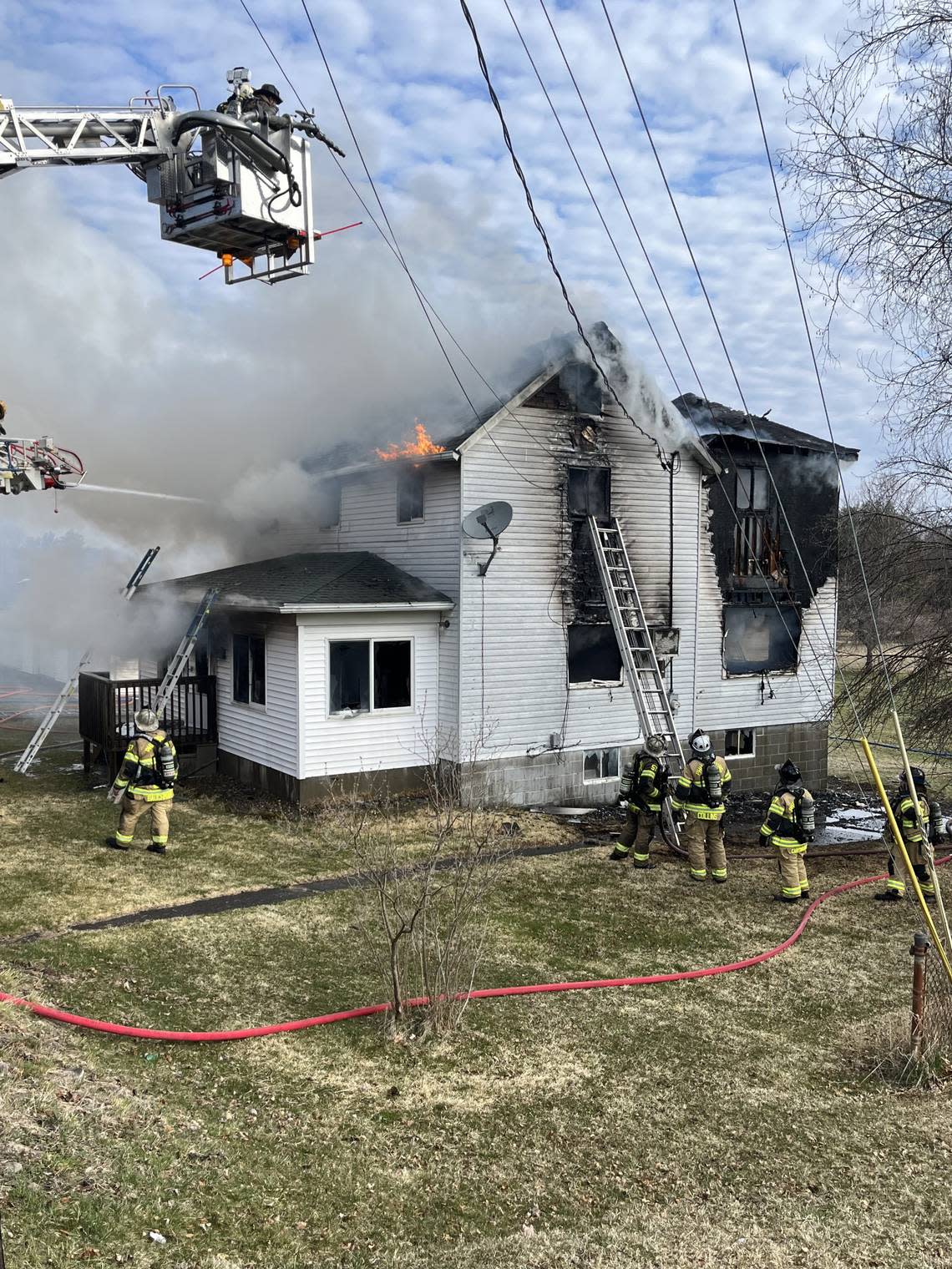 Firefighters work to put out a house fire in the 200 block of One Mile Run Road in Rush Township on Friday morning.