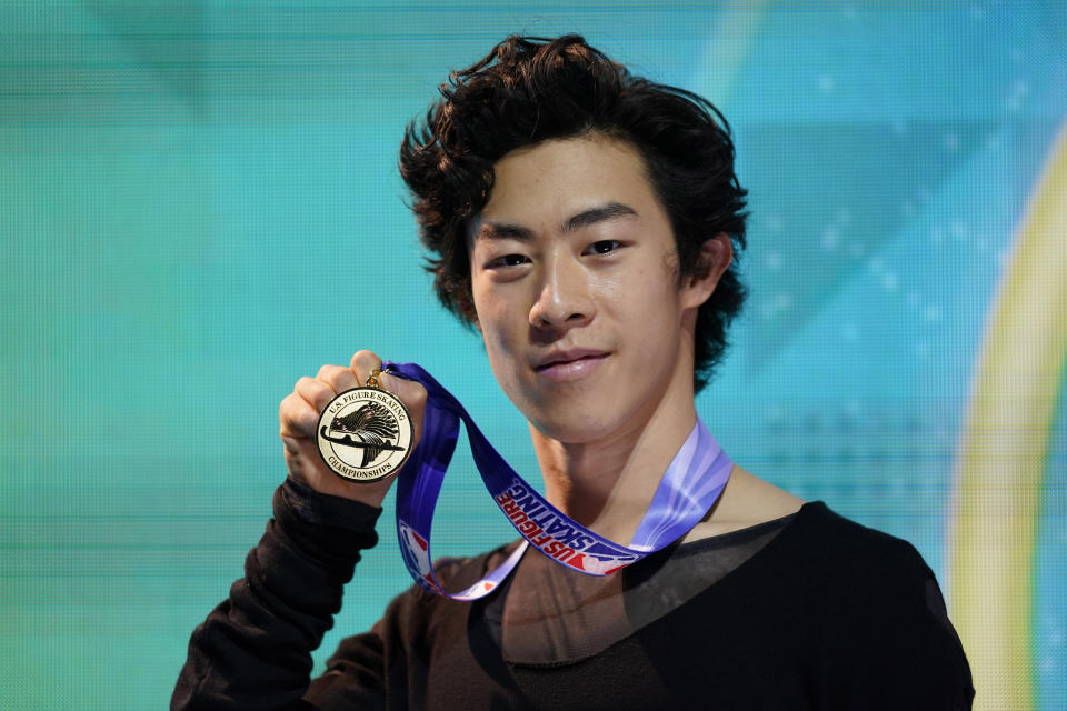 FILE - In this Jan. 17, 2021, file photo, Nathan Chen poses with his gold medal in the men's championship at the U.S. Figure Skating Championships in Las Vegas. Since his disappointing sixth-place finish at the Pyeongchang Olympics, the 22-year-old Chen has won three world titles, the last three of his five U.S. championships, and the two most recent Grand Prix finals. He enters Skate America this weekend as the overwhelming favorite to win his fifth consecutive gold medal. (AP Photo/John Locher, File)