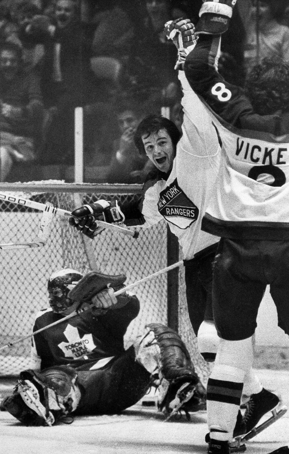FILE - In this Feb. 14, 1977, file photo, New York Rangers Rod Gilbert, center, and Steve Vickers, right, jubilate after Vickers scored a second-period goal against Toronto Maple Leafs goalie Mike Palmateer, left, at Madison Square Garden in New York. Gilbert, the Hall of Fame right wing who starred for the Rangers and helped Canada win the 1972 Summit Series, had died. He was 80. Gilbert’s family confirmed the death to Rangers on Sunday, Aug. 22, 2021. (AP Photo/Ray Stubblebine, File)