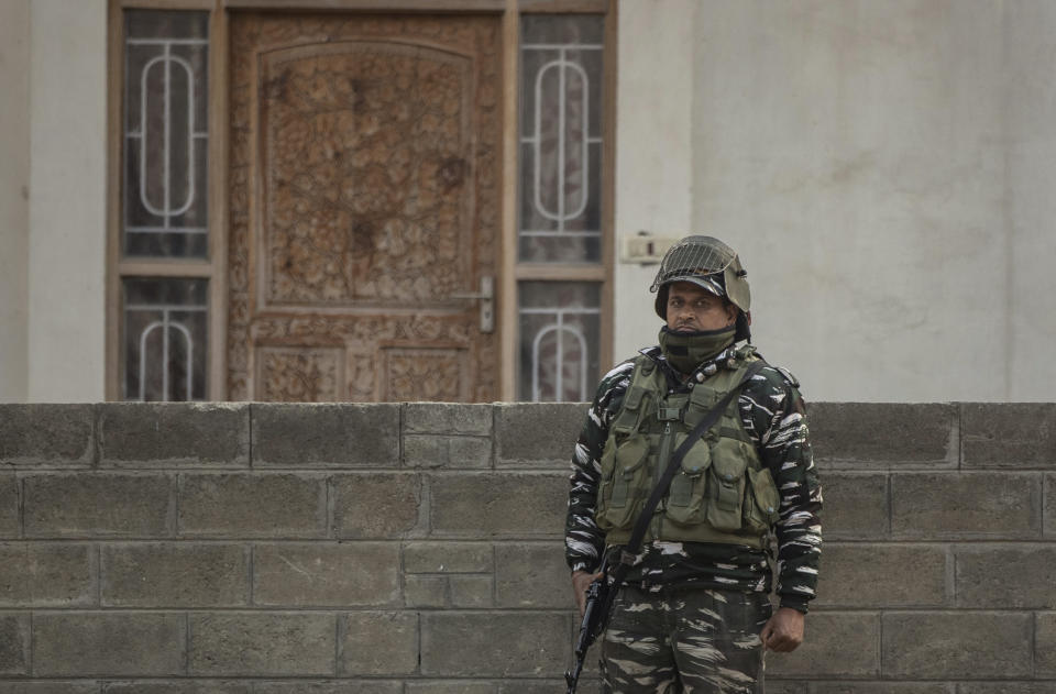 An Indian paramilitary soldier stands guard as National Investigation Agency personnel search the premises of Agence France-Presse’s Kashmir correspondent Parvaiz Bukhari on the outskirts of Srinagar, Indian controlled Kashmir, Wednesday, Oct. 28, 2020. (AP Photo/Mukhtar Khan)