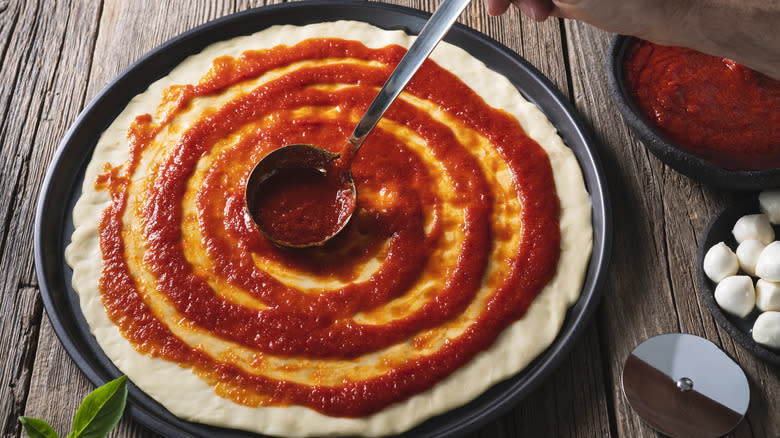 pizza sauce swirled on raw dough