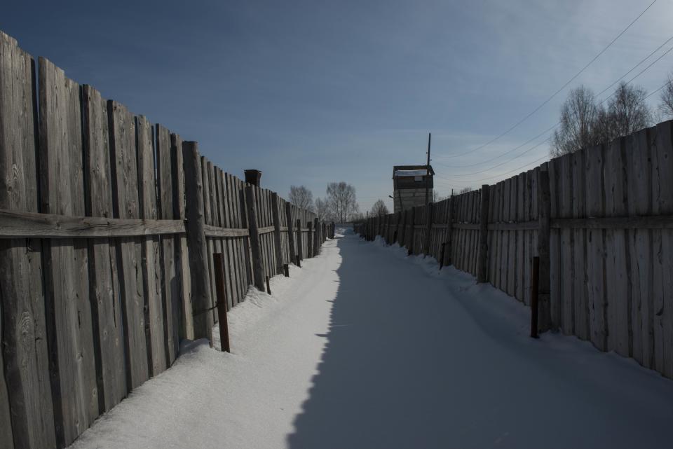 FILE - A double fence that is part of a museum commemorating victims of Soviet-era political repressions, stands inside a former prison camp, some 110 kilometers (69 miles) northeast of the Siberian city of Perm, Russia, on March 6, 2015. Historians estimate that under Soviet dictator Josef Stalin, 700,000 people were executed during the height of his purges in 1937-38. In modern Russia, former inmates, their relatives and human rights advocates paint a bleak picture of the prison system that is descended from the USSR's gulag. For political prisoners, life inside is a grim reality of physical and psychological pressure. (AP Photo/Alexander Agafonov, File)