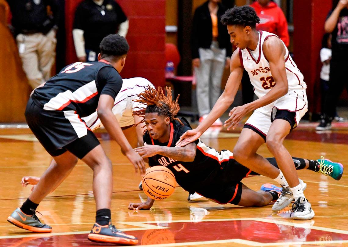 Baldwin guard Tremarius Lawrence (4) dives for a loose ball during the Braves’ 43-42 region championship win over Perry Friday night.