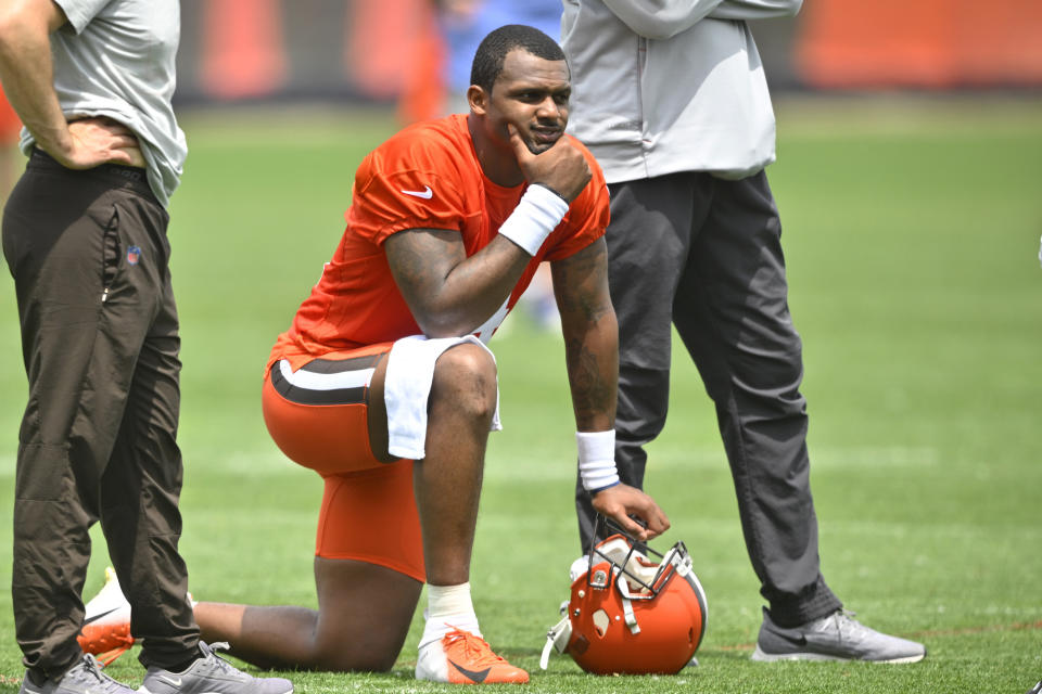 FILE - Cleveland Browns quarterback Deshaun Watson kneels on the field during an NFL football practice at the team's training facility on June 8, 2022, in Berea, Ohio. Thirty women who had accused the Houston Texans of turning a blind eye to allegations that Watson was sexually assaulting and harassing women during massage sessions have settled their legal claims against the team, their attorney said Friday, July 15, 2022. Watson, who has since been traded to the Cleveland Browns, has denied any wrongdoing and vowed to clear his name. (AP Photo/David Richard, File)