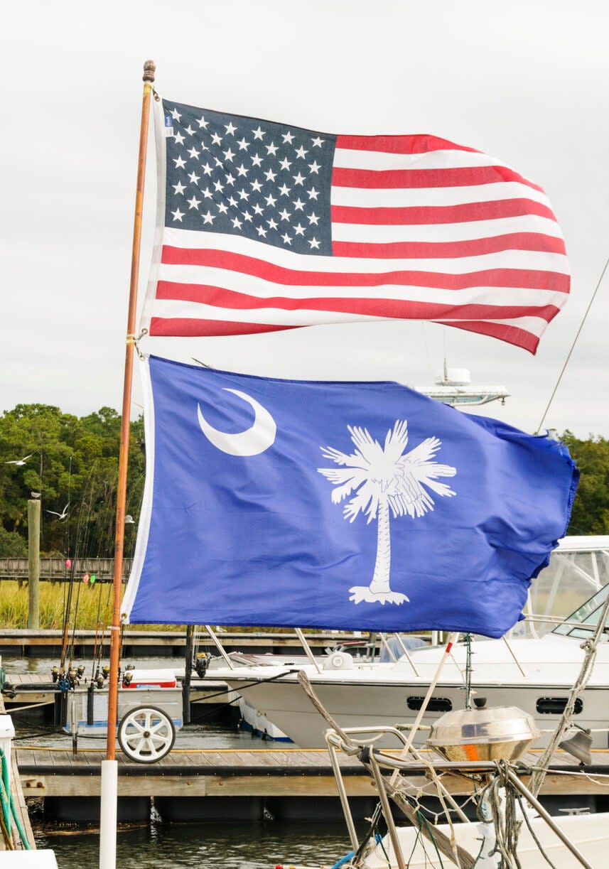 American Flag and South Carolina state flag fly at a dock