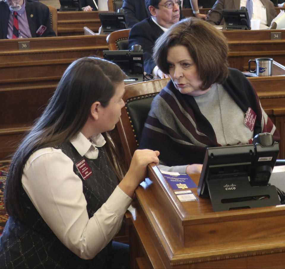 Kansas state Reps. Stephanie Clayton, left, D-Overland Park, and Kathy Wolfe Moore, right, D-Kansas City, confer before a House vote on a resolution condemning a new New York law protecting abortion rights, Wednesday, March 13, 2019, at the Statehouse in Topeka, Kansas. Clayton opposed the resolution, while Wolfe Moore was one of only two Democrats to support it. (AP Photo/John Hanna)