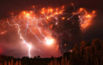 Lightning strikes over the Puyehue volcano, over 500 miles south of Santiago, Chile, Monday June 6, 2011. Authorities have evacuated about 3,500 people in the nearby area. The volcano was calm on Monday, two days after raining down ash and forcing thousands to flee, although the cloud of soot it had belched out still darkened skies as far away as Argentina. (AP Photo/Francisco Negroni, AgenciaUno)