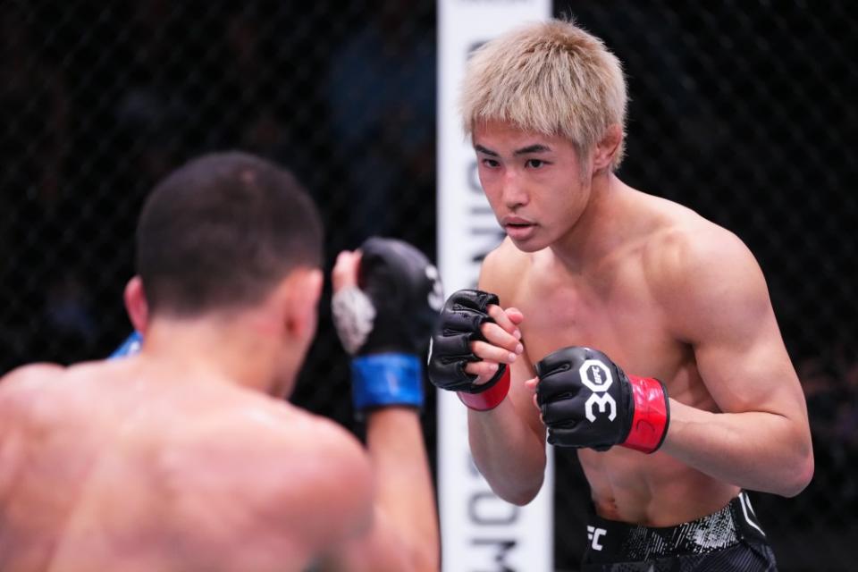 LAS VEGAS, NEVADA – DECEMBER 09: (R-L) Tatsuro Taira of Japan battles Carlos Hernandez in a flyweight fight during the UFC Fight Night event at UFC APEX on December 09, 2023 in Las Vegas, Nevada. (Photo by Jeff Bottari/Zuffa LLC via Getty Images)