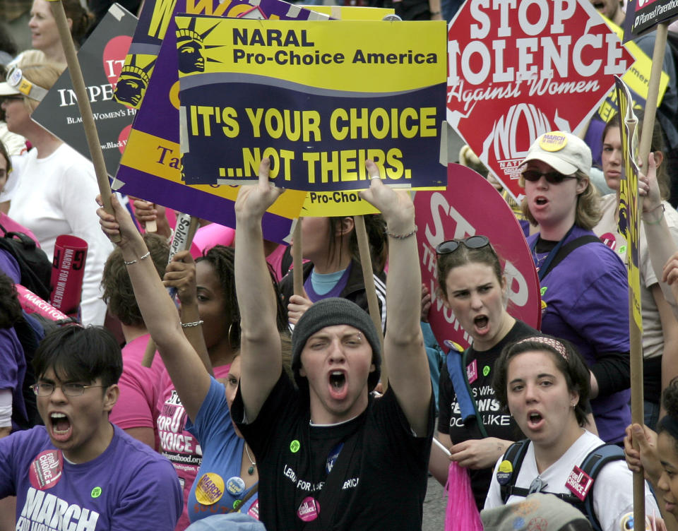 Pro-choice protesters hold up signs on April 25, 2004.