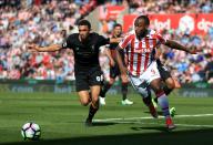 <p>Liverpool’s Trent Alexander-Arnold (left) and Stoke City’s Saido Berahino battle for the ball</p>