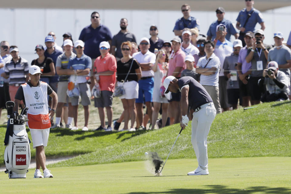 Brooks Koepka hits from the first fairway of the final round in the Northern Trust golf tournament at Liberty National Golf Course, Sunday, Aug. 11, 2019 in Jersey City, N.J. (AP Photo/Mark Lennihan)