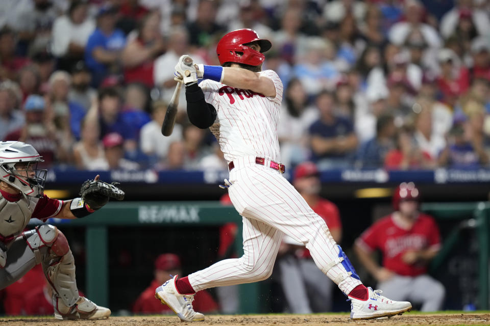 Philadelphia Phillies' Bryce Harper follows through after hitting a two-run home run against Los Angeles Angels pitcher Lucas Giolito during the fourth inning of a baseball game, Monday, Aug. 28, 2023, in Philadelphia. (AP Photo/Matt Slocum)