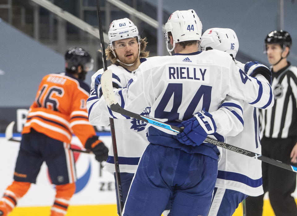 Toronto Maple Leafs' William Nylander (88), Morgan Rielly (44) and Mitchell Marner (16) celebrate a goal against the Edmonton Oilers during first-period NHL hockey game action in Edmonton, Alberta, Monday, March 1, 2021. (Jason Franson/The Canadian Press via AP)